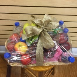Fruit basket wrapped in plastic with a gold bow
