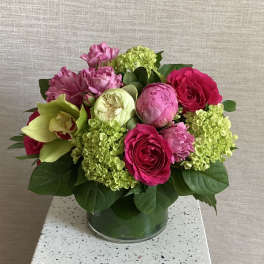 Pink and green floral arrangement in a glass vase