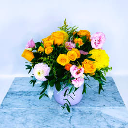 Bouquet of yellow and pink roses in a white vase