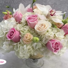 Pink and white rose arrangement in a glass vase