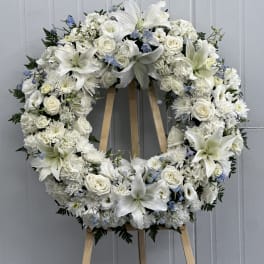 White floral wreath on a wooden easel