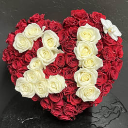 Heart-shaped arrangement of red and white roses