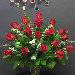 Red roses arranged in a clear glass vase