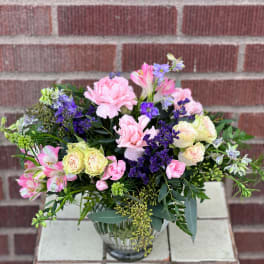 Mixed pink and purple bouquet in a glass vase