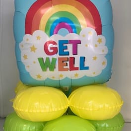 Rainbow "Get Well" balloon arrangement with yellow and green base balloons