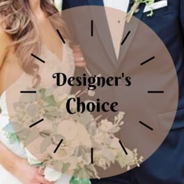Bride holding a white bouquet beside a groom in a tuxedo