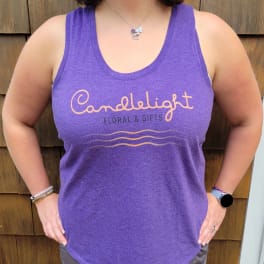 Person wearing a purple tank top with a floral shop logo
