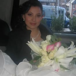 Woman holding a bouquet of white lilies and pink calla lilies