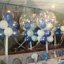 Blue and white balloon decorations at a banquet table setup