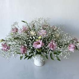 Pink and white floral arrangement in a white vase