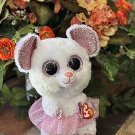 White plush mouse in a pink tutu in front of orange flowers