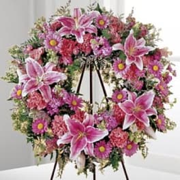 Pink and white floral wreath on a standing easel