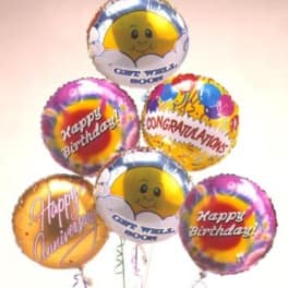 Cluster of colorful birthday and congratulations balloons
