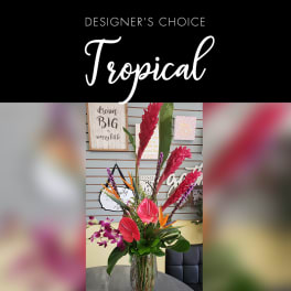 Tall tropical bouquet with red ginger, orchids, and anthuriums in a glass vase