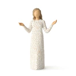 Decorative angel figurine in a white patterned dress with raised arms