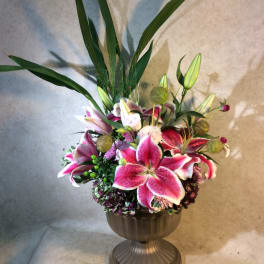 Stargazer Urn, A showy elegant, dispay of Stargazer Lulies, Tropical Foliages, roses Hydrangea.