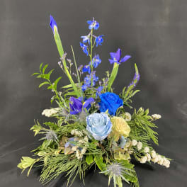 Blue and purple floral arrangement with roses and iris