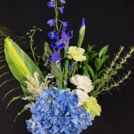 Blue hydrangea bouquet with purple iris and white carnations