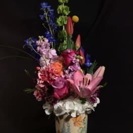 Colorful mixed bouquet in a painted ceramic vase