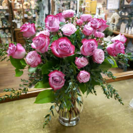 Pink roses arranged in a clear glass vase