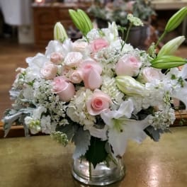 Pink and white floral arrangement in a clear glass vase