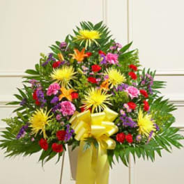 Large mixed flower arrangement with a yellow ribbon bow