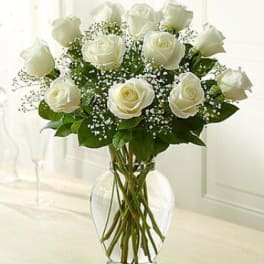 White roses arranged in a clear glass vase