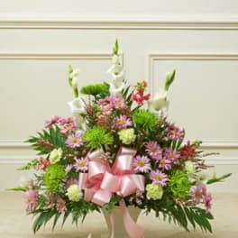 Pink and white mixed flower arrangement with a pink ribbon bow