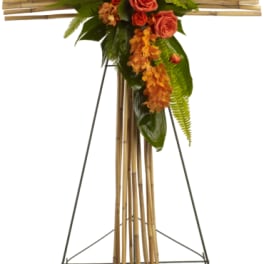 Cross-shaped floral standing spray with orange roses and orchids