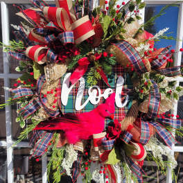 Christmas wreath with plaid ribbons, berries, and a pink bird