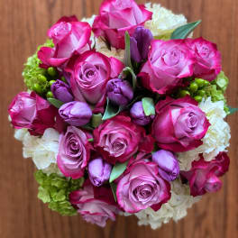 Bouquet of pink roses and purple tulips with white blooms