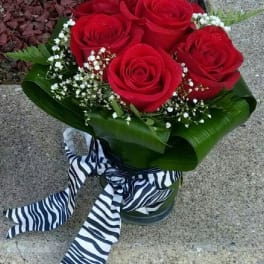 Bouquet of red roses with baby's breath and a striped ribbon