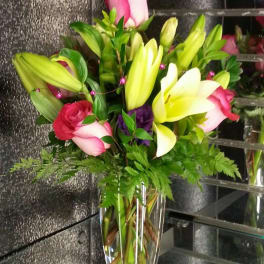 Bouquet of lilies and roses in a clear glass vase
