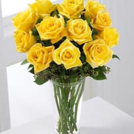 Yellow roses arranged in a clear glass vase