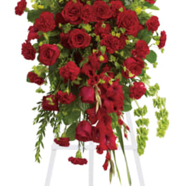 Tall red floral standing spray on a white easel