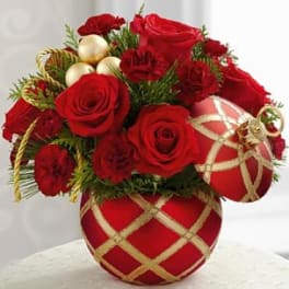 Red roses and carnations in a red ornament vase with gold ribbon accents