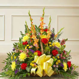 Large mixed flower basket with yellow ribbon and tall orange blooms