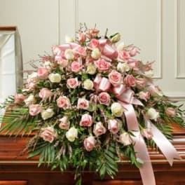 Large pink and white rose casket spray with satin ribbon