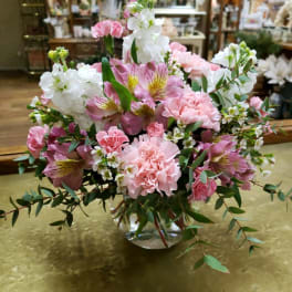 Pink and white floral arrangement in a clear glass vase