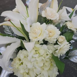 White floral bouquet with lilies, roses, and hydrangea
