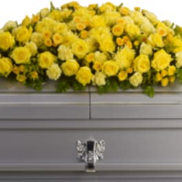 Yellow floral spray on a gray casket