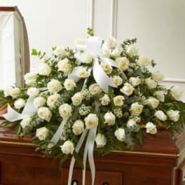 White floral casket spray with roses and calla lilies