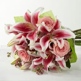 Bouquet of pink lilies and roses with green wrap