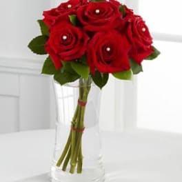 Red rose bouquet in a clear glass vase