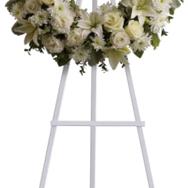 White floral wreath on a standing easel