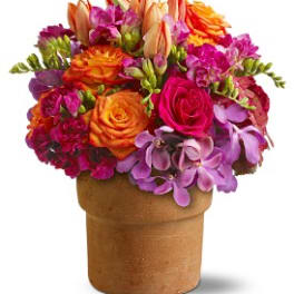 Bright mixed bouquet in a brown vase with orange, pink, and purple flowers