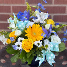Yellow and white bouquet with blue flowers and a baby elephant pick