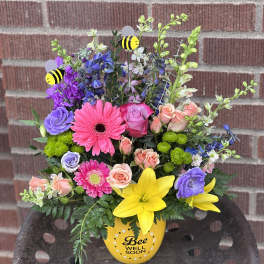Colorful mixed bouquet in a yellow bee-themed vase