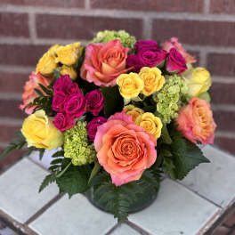 Colorful bouquet of roses in a low vase