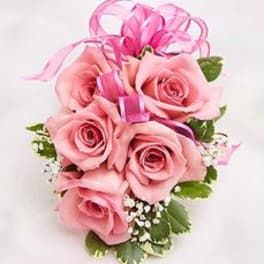 Pink rose bouquet with ribbon and small white filler flowers